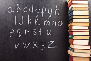 Alphabet on a chalkboard with books